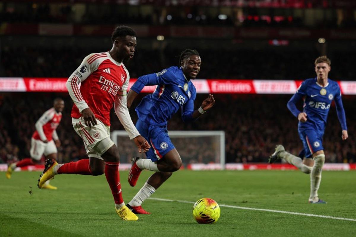 Chelsea's English midfielder #10 Cole Palmer (R) and Chelsea's Belgian midfielder #45 Romeo Lavia (C) challenge Arsenal's English midfielder #07 Bukayo Saka (L) during the English Premier League football match between Arsenal and Chelsea at the Emirates Stadium in London on March 1, 2026.   Adrian Dennis / AFP