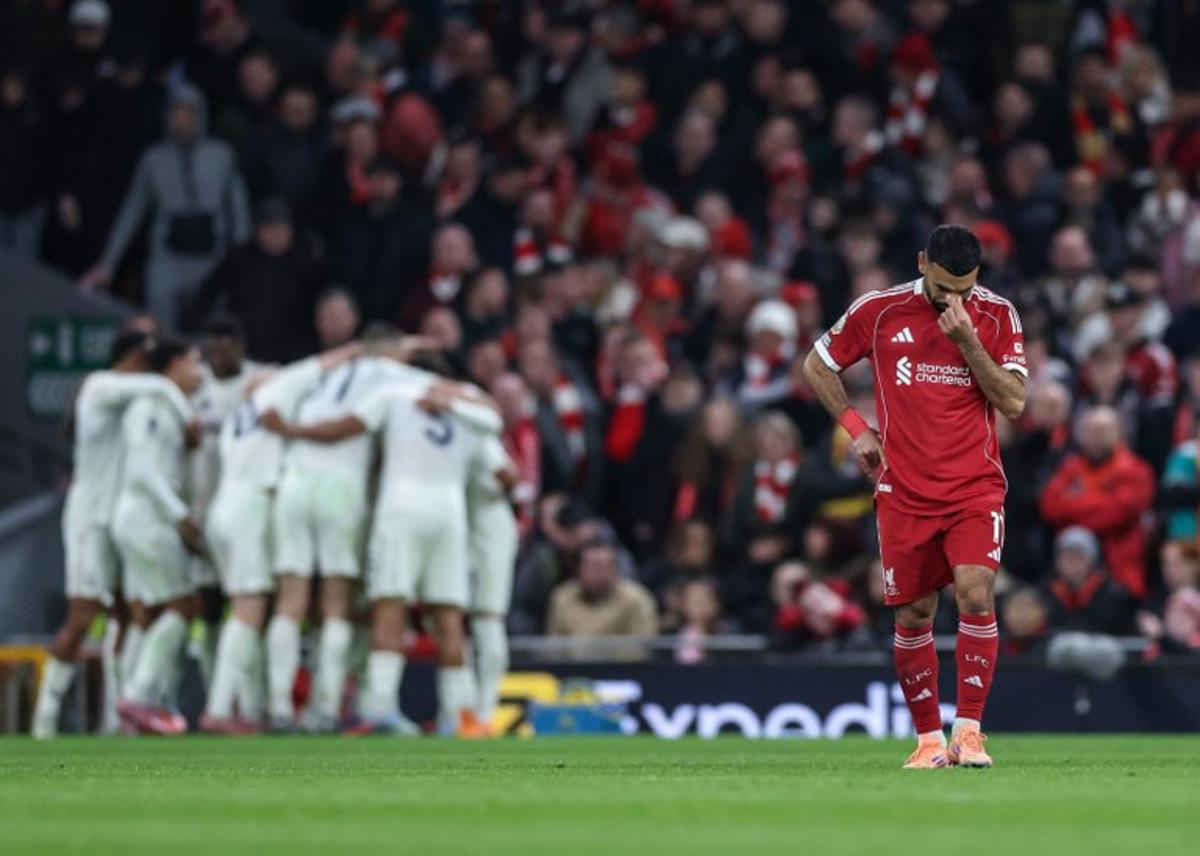 Liverpool's Egyptian striker #11 Mohamed Salah (R) reacts as Nottingham Forrest players (back L) celebrate after their third goal during the English Premier League football match between Liverpool and Nottingham Forest at Anfield in Liverpool, north west England on November 22, 2025.  Darren Staples / AFP