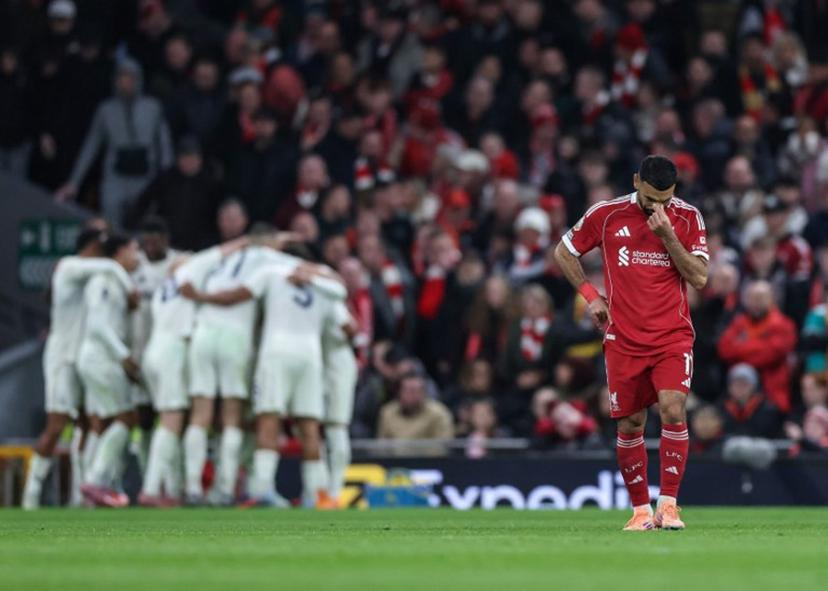 Liverpool's Egyptian striker #11 Mohamed Salah (R) reacts as Nottingham Forrest players (back L) celebrate after their third goal during the English Premier League football match between Liverpool and Nottingham Forest at Anfield in Liverpool, north west England on November 22, 2025.  Darren Staples / AFP