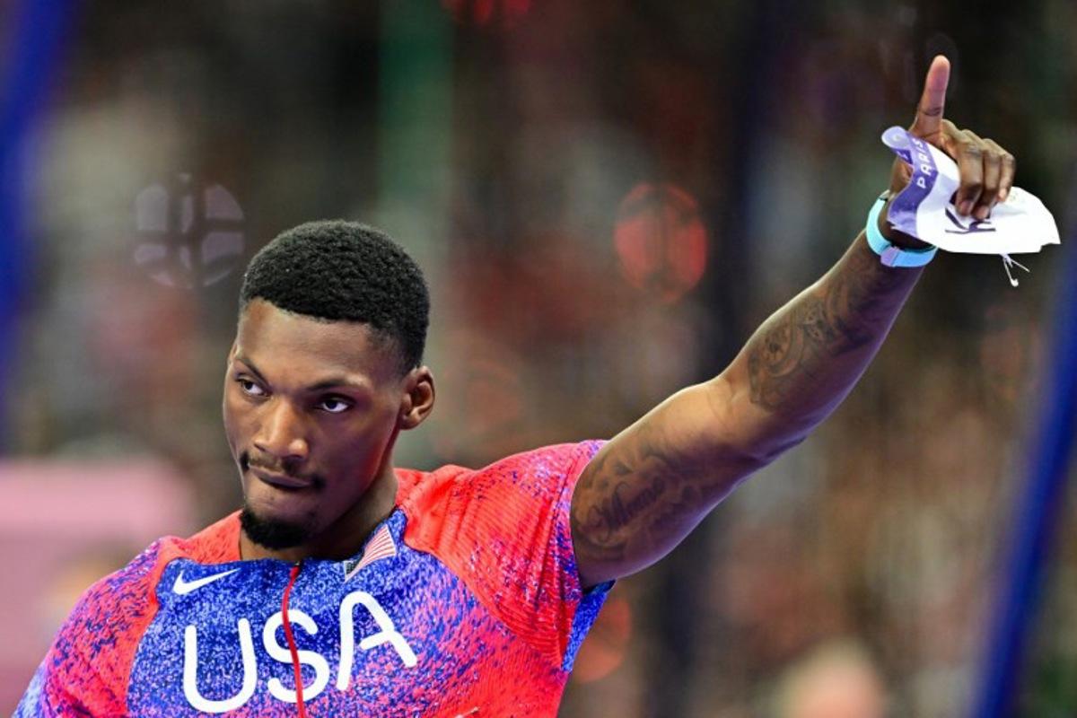 US' bronze medallists Fred Kerley celebrates after the men's 100m final of the athletics event at the Paris 2024 Olympic Games at Stade de France in Saint-Denis, north of Paris, on August 4, 2024.  Martin  BERNETTI / AFP