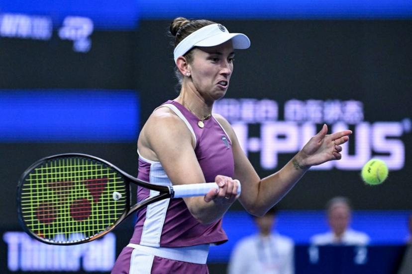 Belgium's Elise Martens hits a return to China's Zheng Qinwen during their women's singles semi-final at the China Open tennis tournament in Beijing on October 10, 2026.  Adek BERRY / AFP
