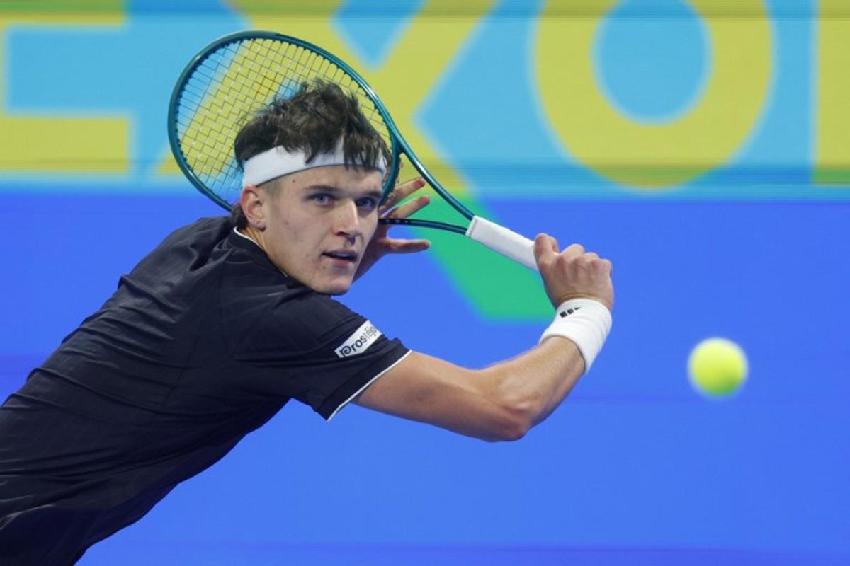 Czech Republic's Jakub Mensik hits a return against France's Arthur Fils during their men's singles semi-final match at the Qatar Open tennis tournament in Doha on February 20, 2026.  Karim JAAFAR / AFP