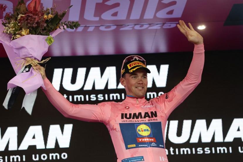 Overall leader Lidl-Trek's Danish rider Mads Pedersen celebrates on the podium of the 6th stage of the 108th Giro d'Italia cycling race 227kms from Potenza to Naples on May 15, 2025.  Luca Bettini / AFP