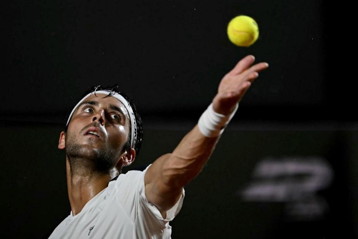 Argentina's Tomas Etcheverry serves against Chile's Alejandro Tabilo during their men's singles final match at the Rio Open tennis tournament in Rio de Janeiro, Brazil, on February 22, 2026.  Mauro PIMENTEL / AFP
