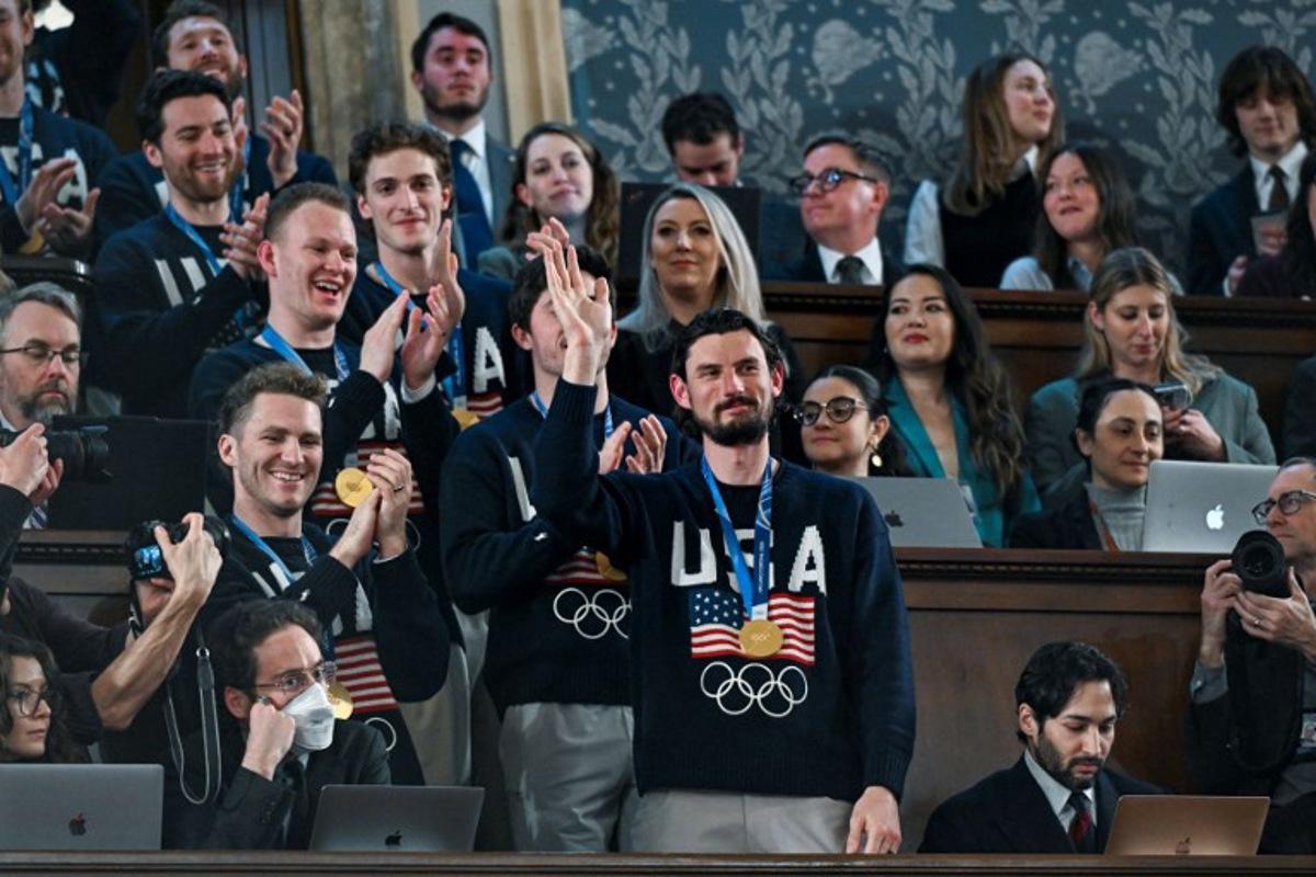 Members of the United States Olympic Men's Ice Hockey Teamare seen in the gallery as President Donald J. Trump delivers the first State of the Union address of his second term to a joint session of Congress in the House Chamber of the United States Capitol in Washington, DC, on February 24, 2026.  Kenny HOLSTON / POOL / AFP
