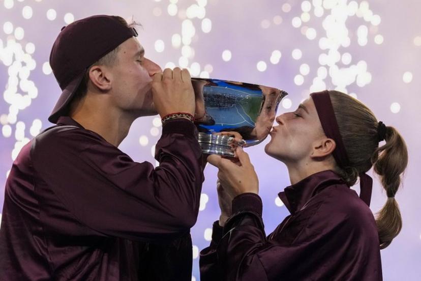 Czech Republic's Jakub Mensik and Czech Republic's Karolina Muchova kiss the trophy while celebrating the victory over Switzerland's Belinda Bencic and Italy's Flavio Cobolli in the mixed doubles final tennis match of the 2026 US Open tennis tournament at the USTA Billie Jean King National Tennis Center in New York on August 26, 2026.  TIMOTHY A. CLARY / AFP