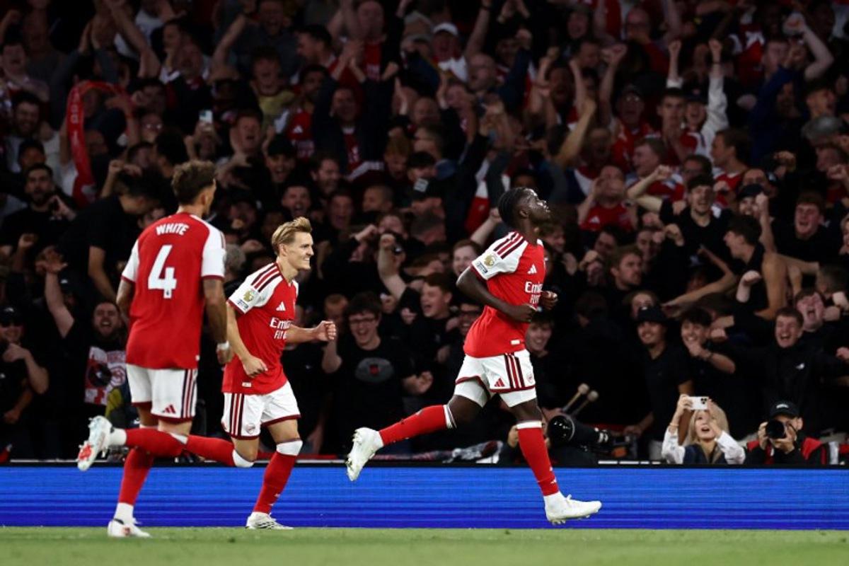 Arsenal's English midfielder #07 Bukayo Saka (R) celebrates scoring the team's second goal during the English Premier League football match between Arsenal and Coventry City at the Emirates Stadium in London on August 21, 2026.   Henry NICHOLLS / AFP