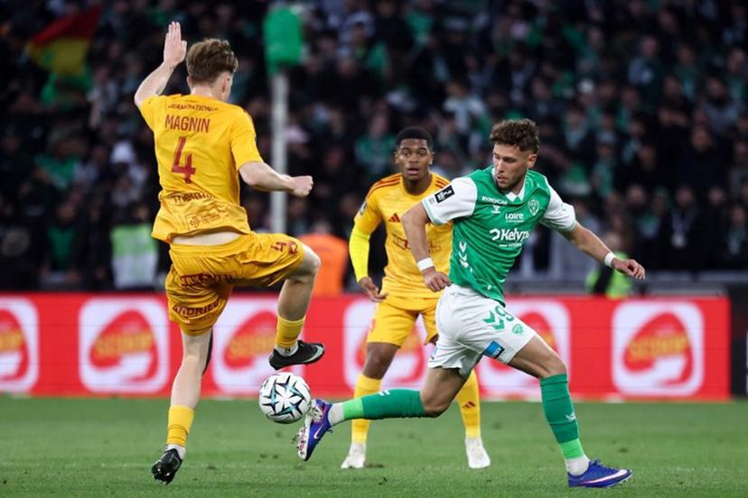 Rodez's Swiss defender #04 Mathis Magnin (L) fights for the ball with Saint-Etienne's Belgian forward #09 Lucas Stassin (R) during the French L1-L2 playoff second leg football match between AS Saint-Etienne and Rodez at the stade Geoffroy Guichard in Saint-Etienne, south-eastern France on May 15, 2026.  Alex MARTIN / AFP