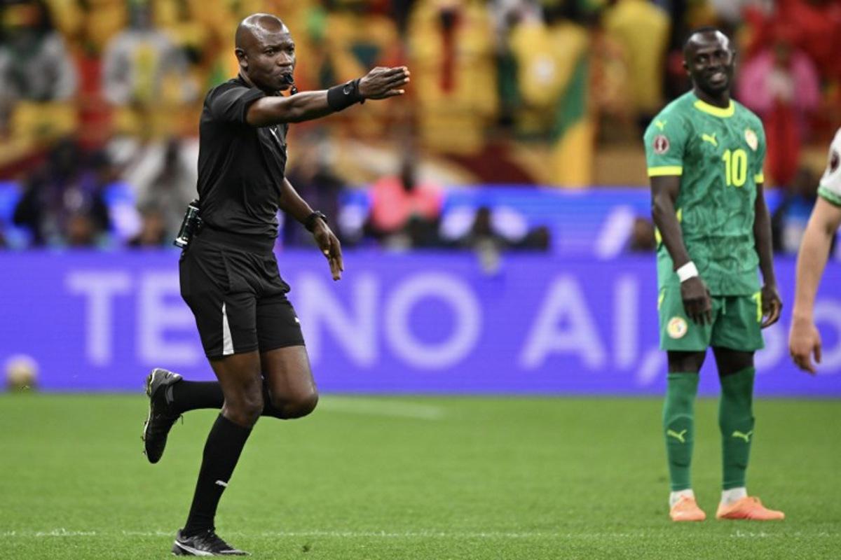 Congolese referee Jean-Jacques Ndala Ngambo whistles a penalty during the Africa Cup of Nations (CAN) final football match between Senegal and Morocco at the Prince Moulay Abdellah Stadium in Rabat on January 18, 2026.   SEBASTIEN BOZON / AFP