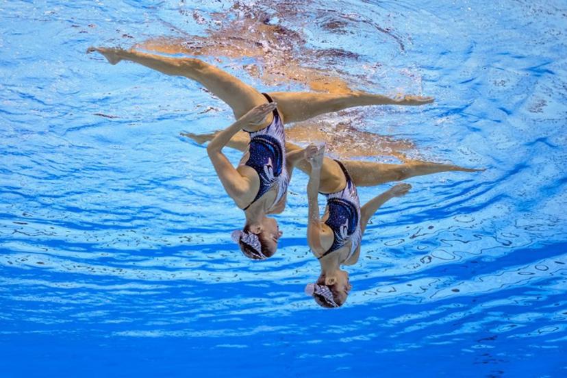 Austria's artistic swimmer Anna-Maria Alexandri and Austria's artistic swimmer Eirini-Marina Alexandri compete in the final of the women's duet technical artistic swimming event during the 2025 World Aquatics Championships in Singapore on July 21, 2025.  FRANCOIS-XAVIER MARIT / AFP