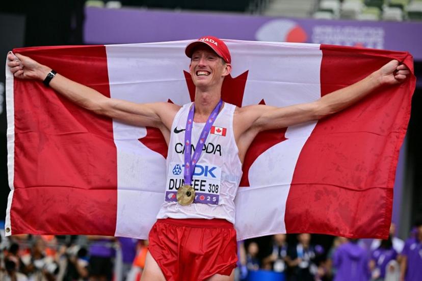 Gold medallist Canada's athlete Evan Dunfee celebrates with his medal after winning the men's 35km race walk final during the World Athletics Championships in Tokyo on September 13, 2025.  Ben STANSALL / AFP