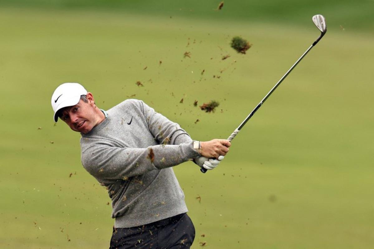 Rory McIlroy of Northern Ireland plays a shot on the 1st hole during the Hero Dubai Desert Classic golf tournament at the Emirates Golf Club in Dubai on January 25, 2026.  Fadel SENNA / AFP