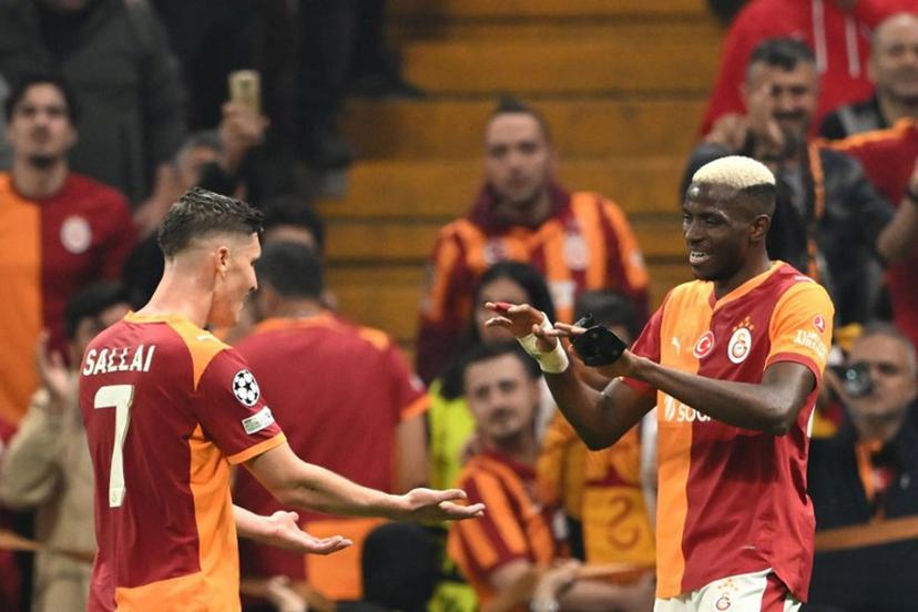 Galatasaray's Nigerian forward #45 Victor Osimhen celebrates with Galatasaray's Hungarian forward #07 Roland Sallai (L) after scoring his team's second goal during the UEFA Champions League, league phase - day 3, football match between Galatasaray SK and Bodo/Glimt at the Rams Park in Istanbul on October 22, 2025.  YASIN AKGUL / AFP