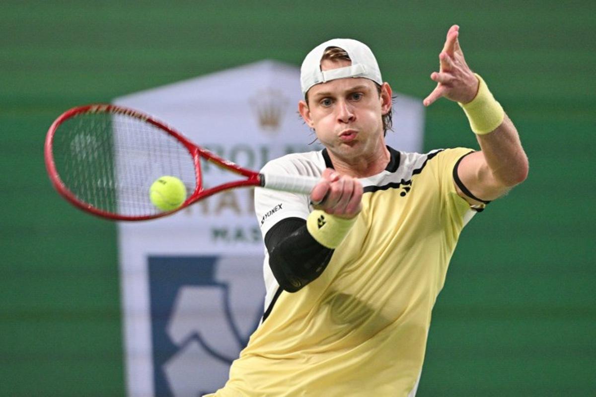 Belgium's Zizou Bergs hits a return to Spain's Carlos Alcaraz during their men's singles match at the Shanghai Masters tennis tournament in Shanghai on October 12, 2026.  Hector RETAMAL / AFP