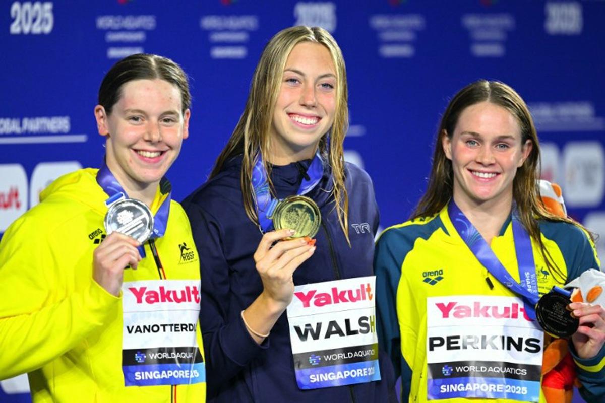 Gold medallist  US' swimmer Gretchen Walsh (C), silver medallist Belgium's swimmer Roos Vanotterdijk (L) and bronze medallist Australia's swimmer Alexandria Perkins (R) pose on the podium of the women's 100m butterfly swimming event during the 2025 World Aquatics Championships in Singapore on July 28, 2025.  François-Xavier MARIT / AFP
