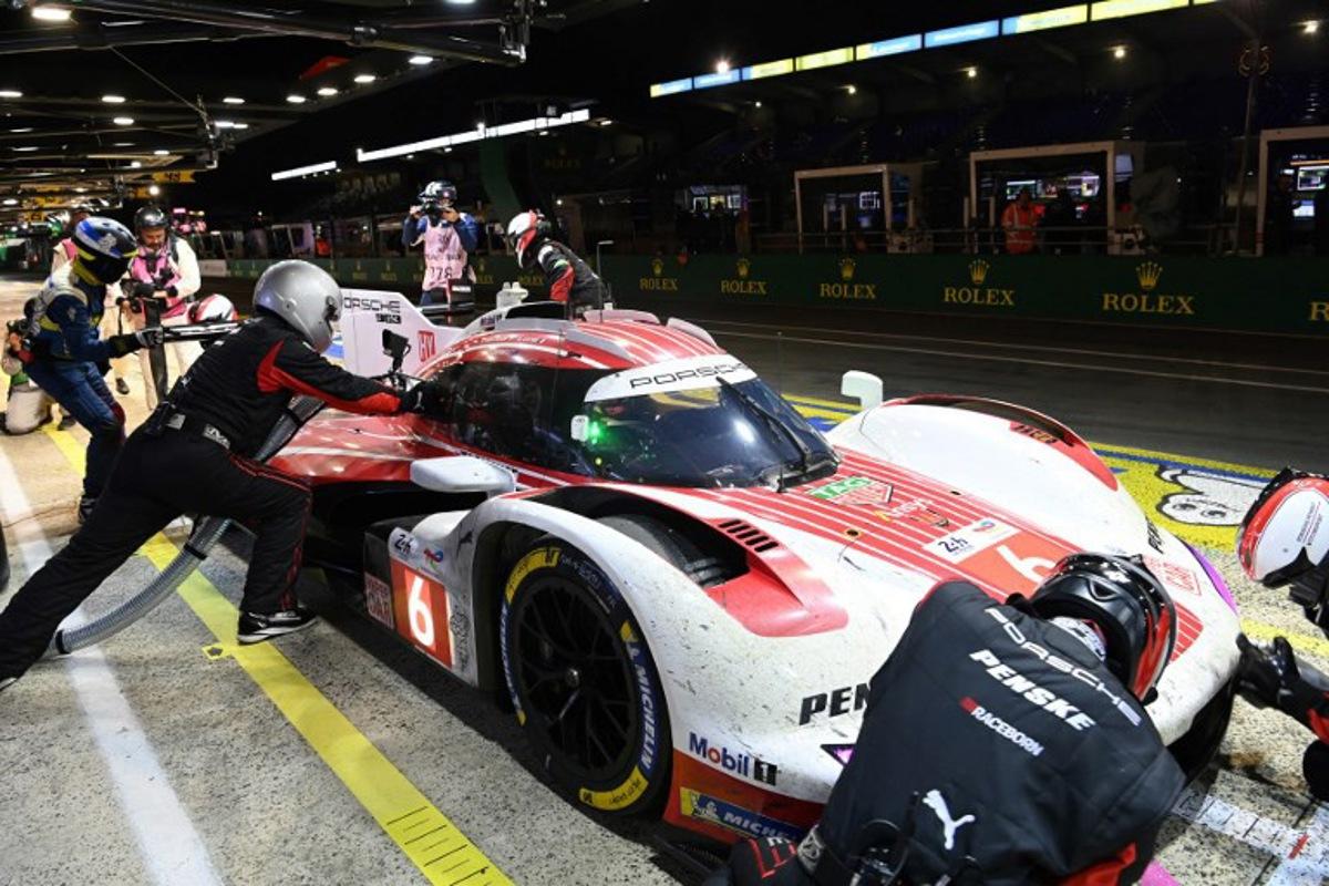 Porsche Penske Motorsport Thor Team's hypercar # 06 Belgian driver Laurens Vanthoor refuels in their pit  during the 2025 Le Mans 24 hour endurance race, at the Le Mans circuit, in northwestern France, on June 15, 2025.  JEAN-FRANCOIS MONIER / AFP