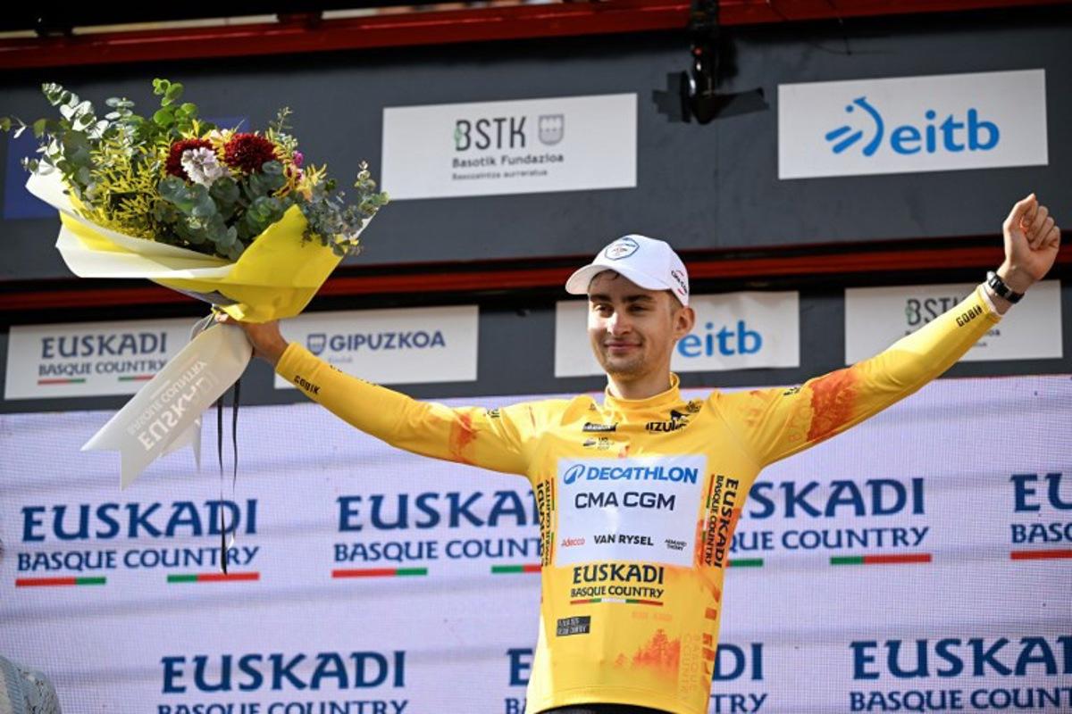 Team Decathlon CMA CGM's French rider Paul Seixas, the overall race leader and winner of the fifth stage of the Basque Country's Itzulia cycling tour, a 176.2 km race starting and finishing in Eibar, celebrates on the podium on April 10, 2026.   ANDER GILLENEA / AFP