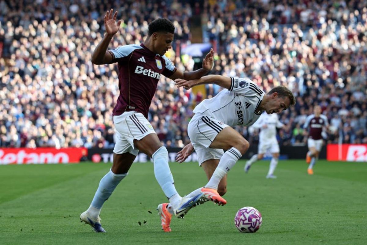 Aston Villa's English striker #11 Ollie Watkins (L) vies with Fulham's Belgian defender #21 Timothy Castagne during the English Premier League football match between Aston Villa and Fulham at Villa Park in Birmingham, central England on September 28, 2025.  Darren Staples / AFP