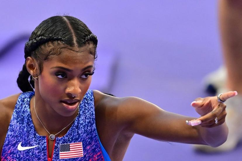 US' Masai Russell reacts after winning the women's 100m hurdles final of the athletics event at the Paris 2024 Olympic Games at Stade de France in Saint-Denis, north of Paris, on August 10, 2024.  Martin  BERNETTI / AFP
