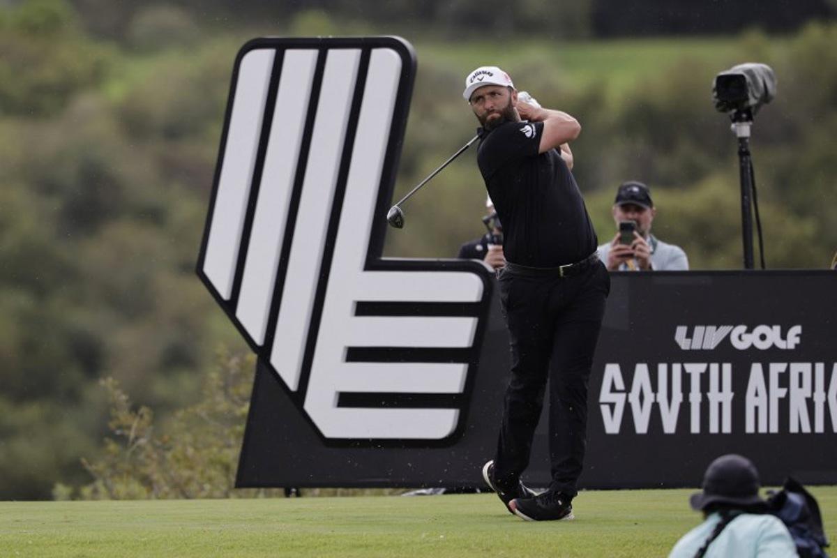 Legion XIII's Spanish player Jon Rahm watches a drive from the 14th tee on the fourth day of the LIV Golf South Africa tournament at The Club in Steyn City on March 22, 2026.  WIKUS DE WET / AFP