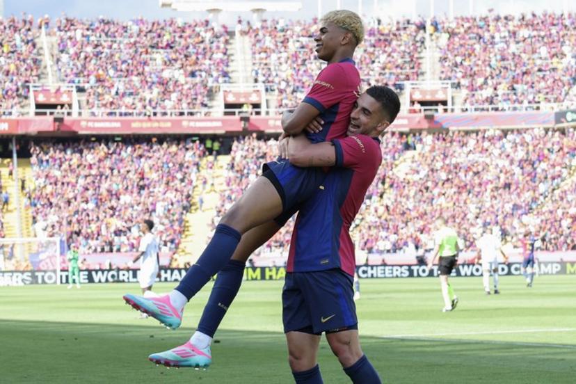 Barcelona's Spanish forward #19 Lamine Yamal celebrates scoring his team's second goal with Barcelona's Spanish forward #07 Ferran Torres during the Spanish league football match between FC Barcelona and Real Madrid CF at Estadi Olimpic Lluis Companys in Barcelona, on May 11, 2025.  LLUIS GENE / AFP