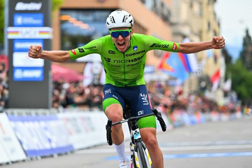 Slovenia's Tadej Pogacar celebrates as he crosses the finish line to win the men's Elite Road Race cycling event during the UCI 2024 Road World Championships, in Zurich, on September 29, 2024.  Fabrice COFFRINI / AFP