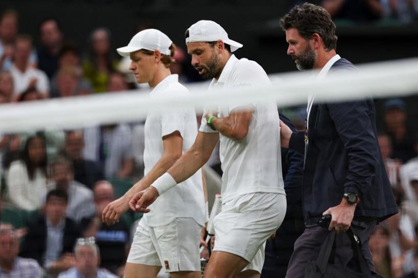 Bulgaria's Grigor Dimitrov (C) reacts as he walks next to Italy's Jannik Sinner (L) and medical staff after getting injured during the men's singles fourth round tennis match on the eighth day of the 2025 Wimbledon Championships at The All England Lawn Tennis and Croquet Club in Wimbledon, southwest London, on July 7, 2025.  Adrian Dennis / AFP