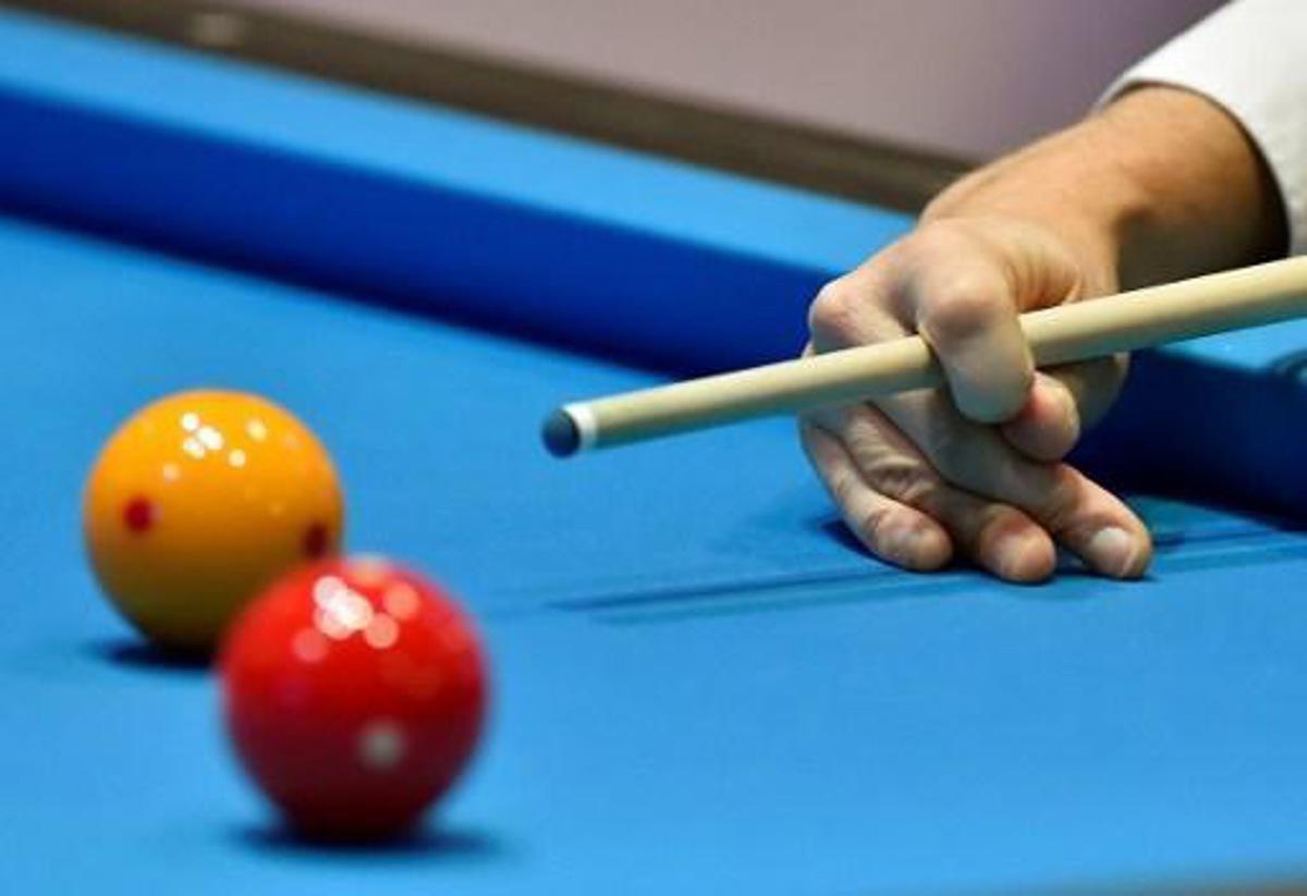 A player competes in the qualification round of the 3-Cushion Billiards World Championship in Bordeaux on November 15, 2016. 
GEORGES GOBET / AFP