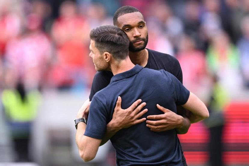 Bayer Leverkusen's Spanish head coach Xabi Alonso embraces Bayer Leverkusen's German defender #04 Jonathan Tah after the German first division Bundesliga football match between Mainz 05 and Bayer Leverkusen in Mainz, western Germany, on May 17, 2025.  Kirill KUDRYAVTSEV / AFP