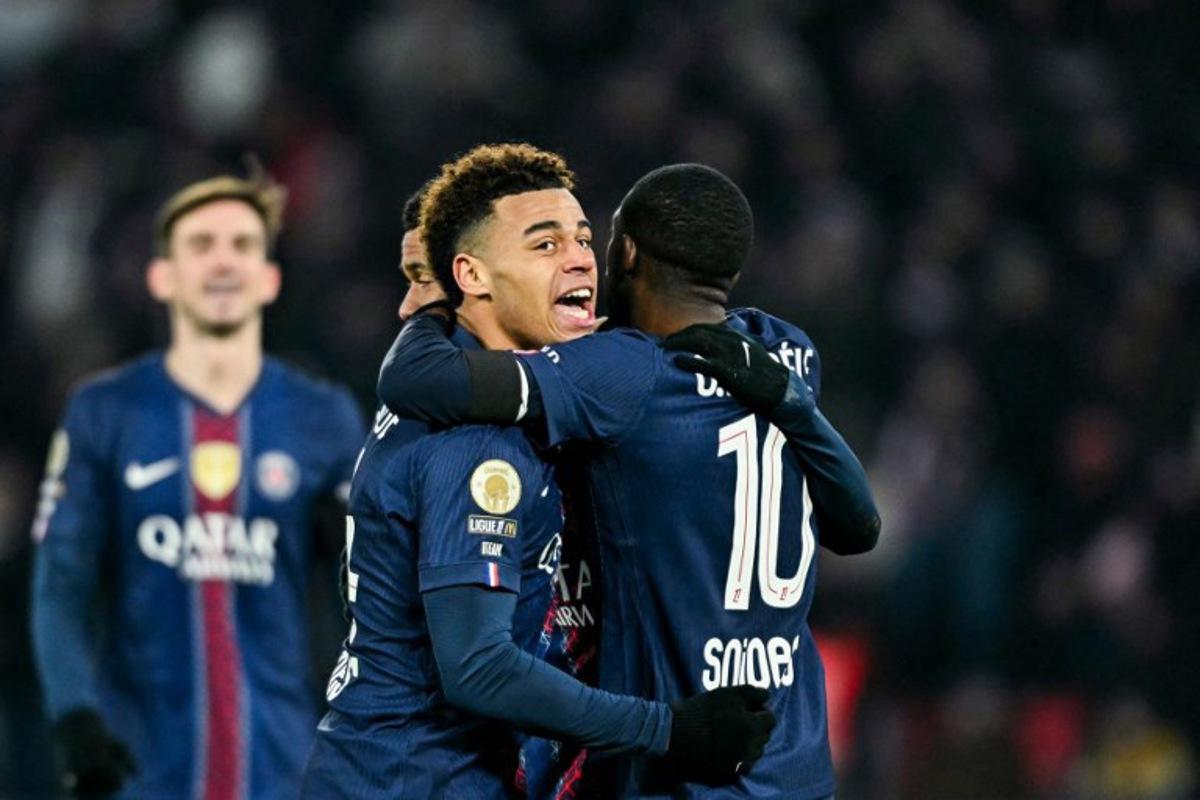 Paris Saint-Germain's French forward #10 Ousmane Dembele (R) celebrates with Paris Saint-Germain's French midfielder #14 Desire Doue after scoring his team's second goal during the French L1 football match between Paris Saint-Germain (PSG) and Paris FC at the Parc des Princes stadium in Paris on January 4, 2026.  Blanca CRUZ / AFP