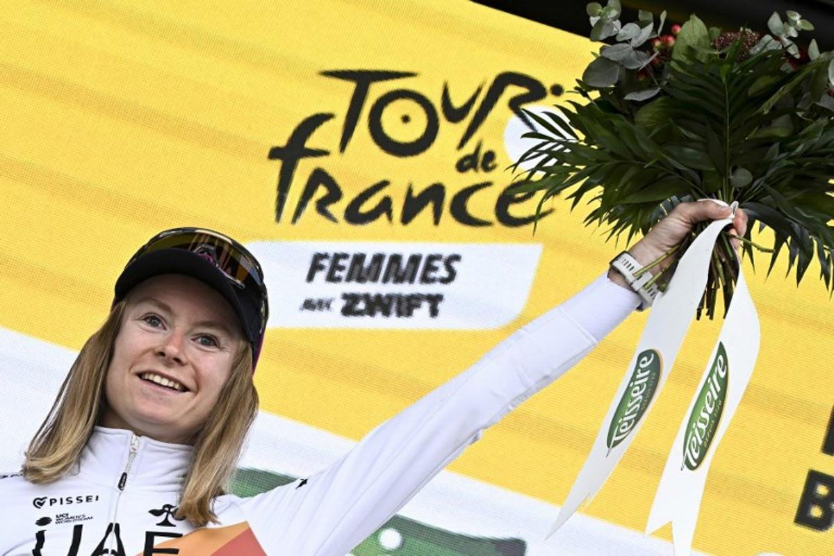 UAE Team ADQ's French rider Maeva Squiban celebrates winning the combativity award on the podium of the 2nd stage (out of 9) of the fourth edition of the Women's Tour de France cycling race, 110,4 km from Brest to Quimper on July 27, 2025.  Julien DE ROSA / AFP