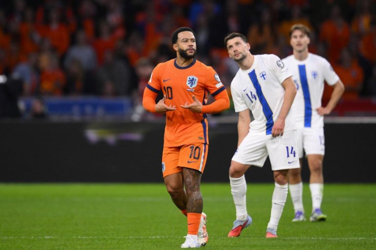 Netherlands' forward #10 Memphis Depay (L) celebrates scoring his team's third goal from the penalty spot during the FIFA World Cup 2026 Group G qualification football match between Netherlands and Finland, at the Johan Cruyff Arena in Amsterdam, on October 12, 2025.  JOHN THYS / AFP