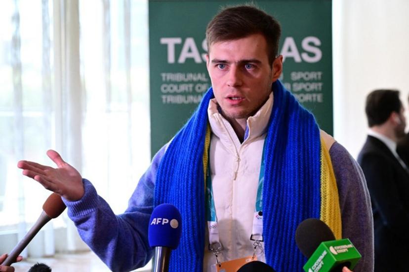 Ukrainian skeleton athlete Vladyslav Heraskevych speaks to the press after a hearing at the Court of Arbitration for Sport (TAS) in Milan on February 13, 2026. Heraskevych was barred from the Milan-Cortina Games after refusing to back down from wearing a helmet adorned with pictures of Ukrainian sportsmen and women killed since Russian invaded in 2022. PIERO CRUCIATTI / AFP