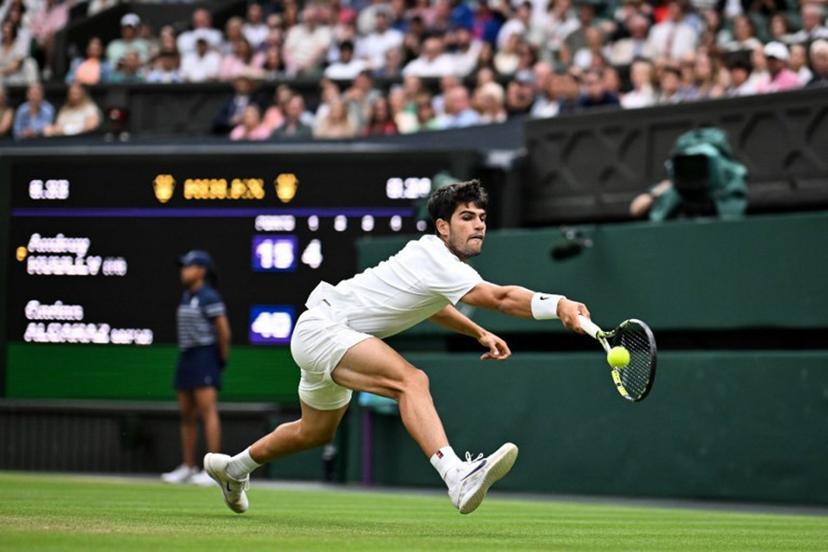 Spain's Carlos Alcaraz plays a backhand return to Russia's Andrey Rublev during their men's singles fourth round tennis match on the seventh day of the 2025 Wimbledon Championships at The All England Lawn Tennis and Croquet Club in Wimbledon, southwest London, on July 6, 2025.  Kirill KUDRYAVTSEV / AFP
