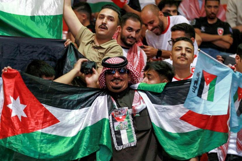 Jordan's fans cheer as they watch the 2026 FIFA World Cup Asian Qualifier football match between Jordan and Oman on big screens at the Prince Hamza hall in the Sports City in Amman on June 5, 2025.  Khalil MAZRAAWI / AFP