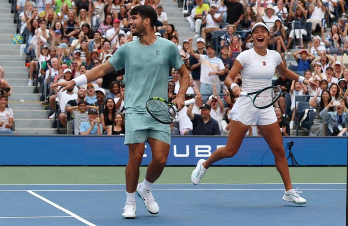 Britain's Emma Raducanu and Carlos Alcaraz of Spain celebrate a point during their first round mixed doubles match against Jessica Pegula of the US and Jack Draper of Britain at the US Open tennis tournament at the USTA Billie Jean King National Tennis Center in New York City on August 19, 2025.  TIMOTHY A. CLARY / AFP