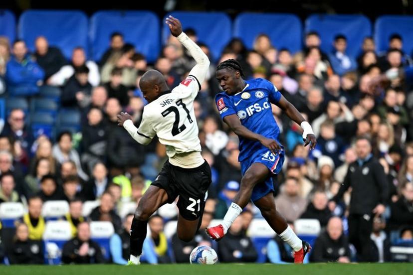 Chelsea's Belgian midfielder #45 Romeo Lavia battles for the ball with Port Vale's Liberian forward #21 Martin Sherif during the English FA Cup quarter final football match between Chelsea and Port Vale at Stamford Bridge in London on April 4, 2026.  Ben STANSALL / AFP