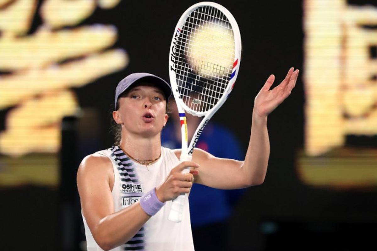 Poland's Iga Swiatek celebrates victory over China's Yuan Yue after their women's singles match on day two of the Australian Open tennis tournament in Melbourne on January 19, 2026.  DAVID GRAY / AFP