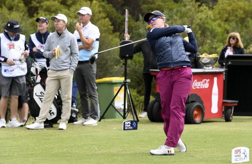 Female golfer Manon De Roey of Belgium (R) tees off as male players Gavin Moynihan of Ireland (3/L) and Dale Williamson of Australia (4/L) look on during the third round of the joint EPGA  and LPGA Vic Open golf tournament at the 13th Beach Golf Links at Barwon Heads near Melbourne on February 9, 2019.  WILLIAM WEST / AFP