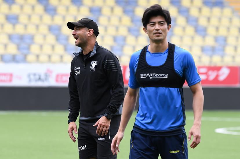 STVV's head coach Frederic De Meyer and STVV's Shogo Taniguchi pictured during a training session of Belgian soccer team Sint-Truidense V.V., Wednesday 19 August 2026 in Sint-Truiden, in preparations of the first leg of the play-off round for the UEFA Europa League league phase, against Cypriot team AC Omonoia Nicosia. BELGA PHOTO JILL DELSAUX