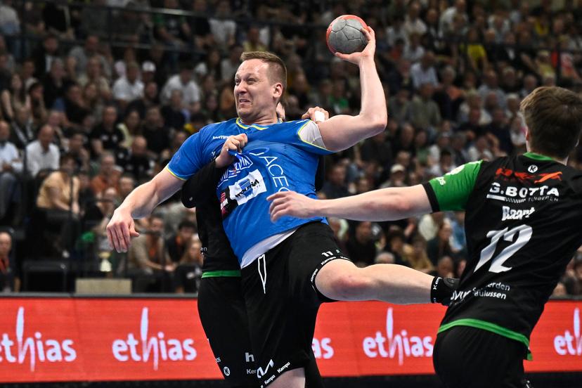 Bocholt's Rafal Przybylski fights for the ball during a handball game between Hubo handbal Hasselt and Achilles Bocholt, Saturday 19 April 2025, in Hasselt, the men's final of the Belgian handball cup. BELGA PHOTO JOHAN EYCKENS