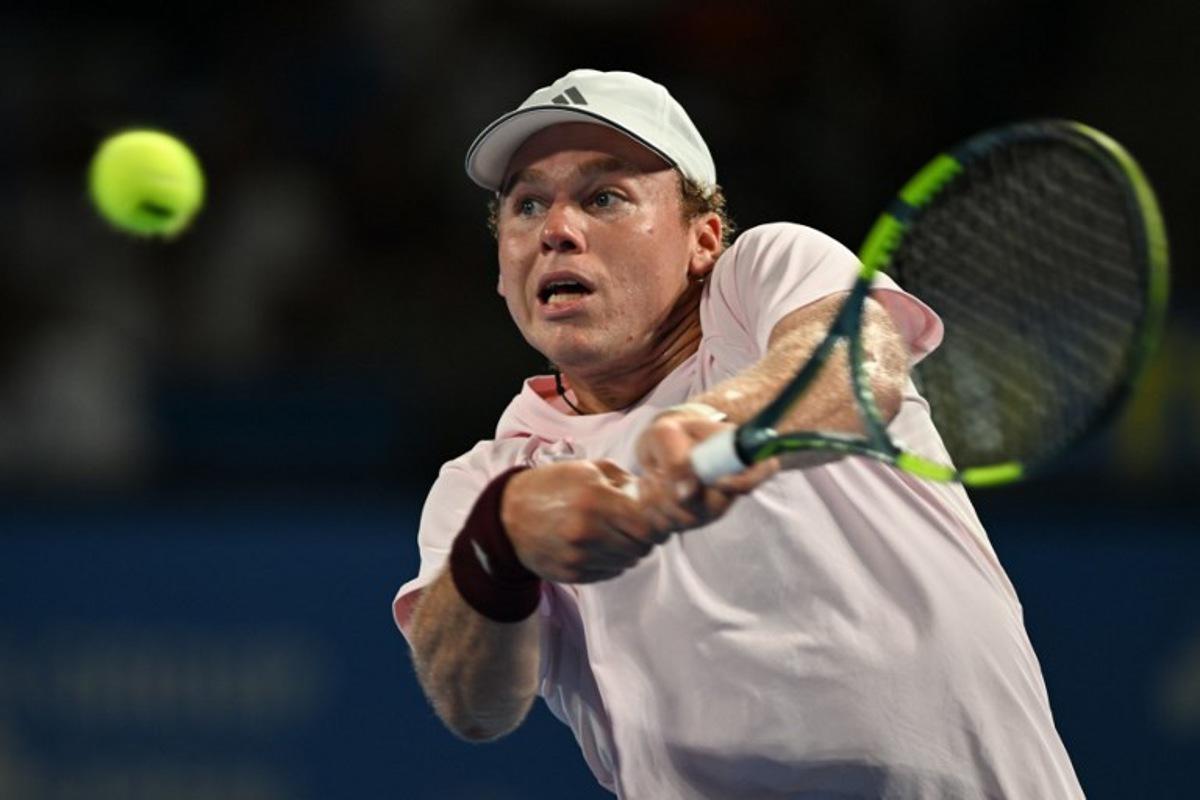 USA's Alex Michelsen plays a shot to Spain's Carlos Alcaraz during their men's singles tennis match at the ATP Tour Japan Open Tennis Championships at the Ariake Tennis Forest Park in Tokyo on October 1, 2026.  Rie KIKUCHI / AFP