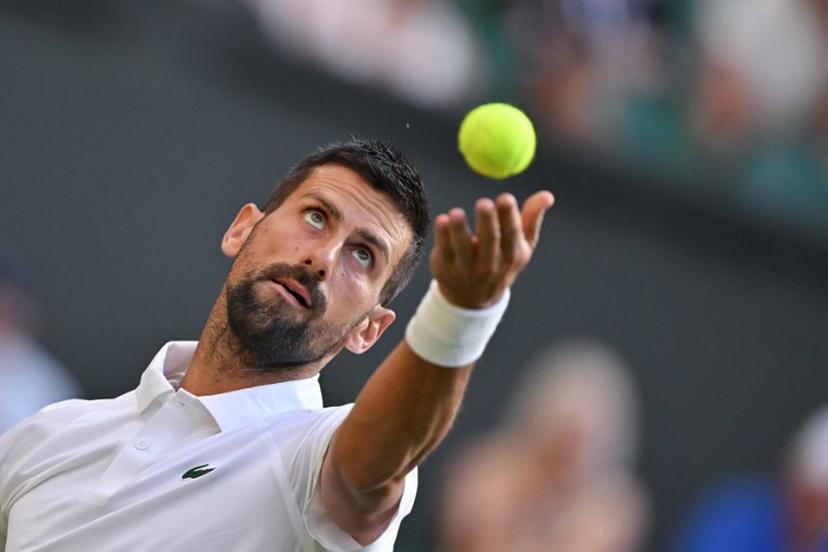 Serbia's Novak Djokovic serves to France's Alexandre Muller during their men's singles first round tennis match on the second day of the 2025 Wimbledon Championships at The All England Lawn Tennis and Croquet Club in Wimbledon, southwest London, on July 1, 2025.  Glyn KIRK / AFP