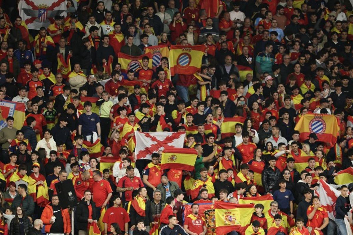 Spain supporters hold up flags during the international friendly football match between Spain and Egypt at RCDE Stadium in Cornella de Llobregat, near Barcelona, on March 31, 2026. Police in Spain said on Wednesday that they were investigating "Islamophobic and xenophobic" chants heard during the Spain-Egypt international football match in Barcelona. Egypt's national anthem was jeered ahead of the 0-0 draw in Barcelona on Tuesday in a pre-World Cup friendly and authorities at the RCDE Stadium appealed to fans more than once over the public announcement system to refrain from making offensive comments.  Lluis GENE / AFP