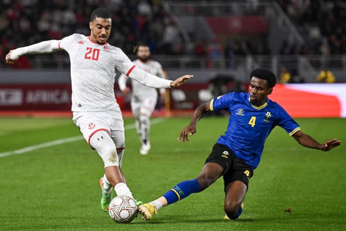 Tunisia's defender #20 Yan Valery and Tanzania's defender #04 Ibrahim Hamad vie during the Africa Cup of Nations (CAN) Group C football match between Tanzania and Tunisia at Rabat Olympic Stadium in Rabat on December 30, 2025.   Paul ELLIS / AFP