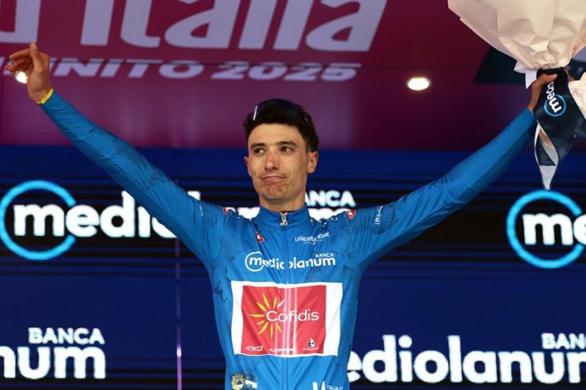 Cofidis' Belgian rider Sylvain Moniquet wears the best climber's blue jersey on the podium after the first stage of the 108th Giro d'Italia cycling race, 160km from Durres to Tirana in Albania, on May 9, 2025.  Luca Bettini / AFP