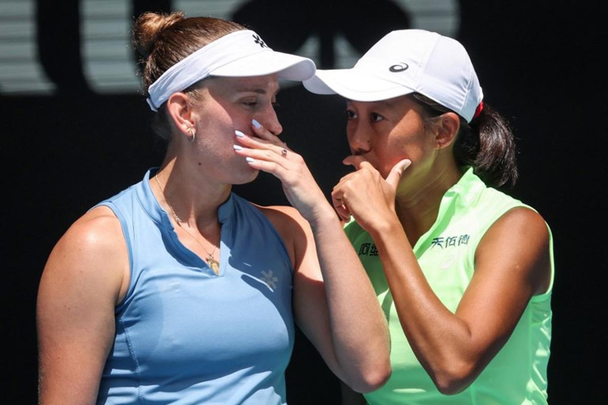 Belgium's Elise Mertens (L) talks to partner China's Zhang Shuai during their women's doubles final match against Kazakhstan's Anna Danilina and Serbia's Aleksandra Krunic on day fourteen of the Australian Open tennis tournament in Melbourne on January 31, 2026.  DAVID GRAY / AFP
