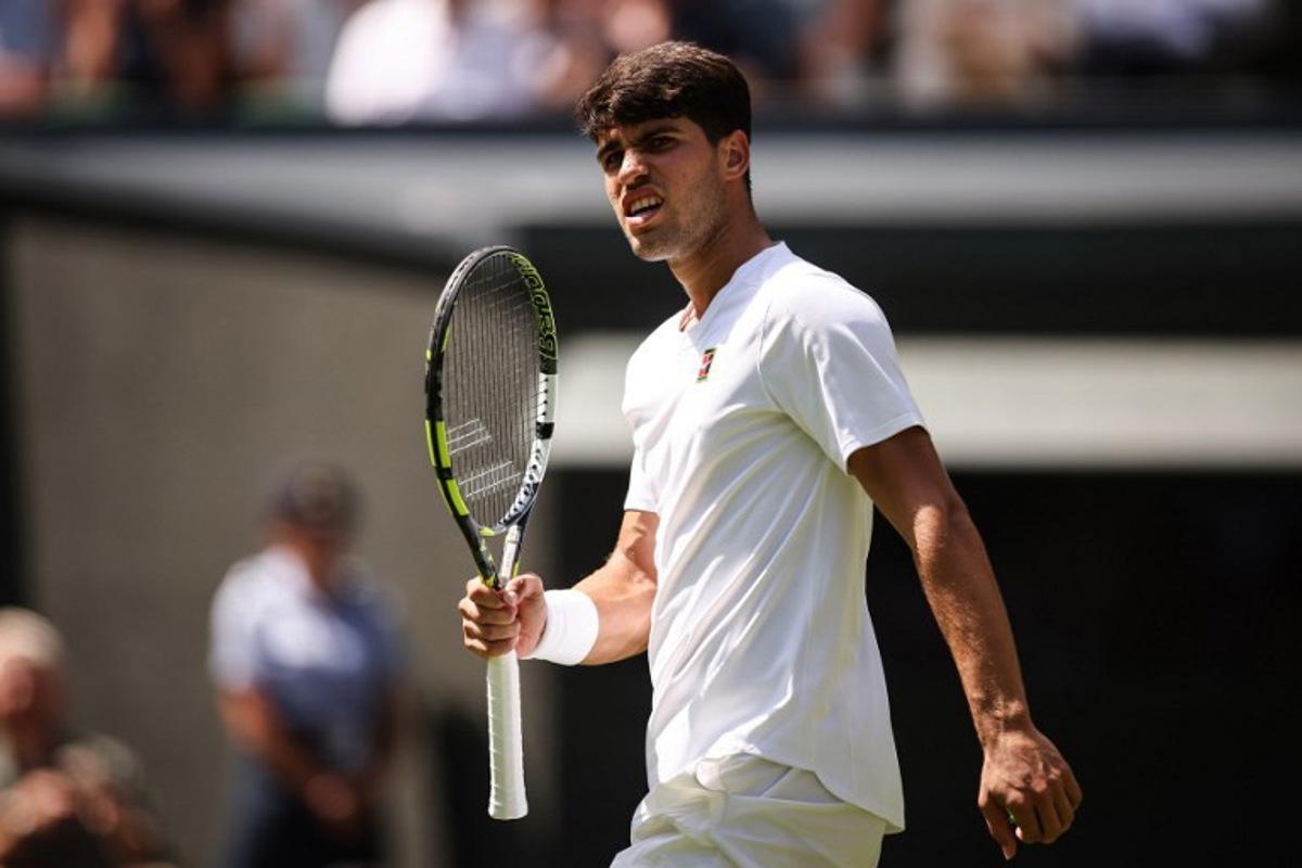 Spain's Carlos Alcaraz celebrates winning the first set to Italy's Fabio Fognini during their men's singles first round tennis match on the first day of the 2025 Wimbledon Championships at The All England Lawn Tennis and Croquet Club in Wimbledon, southwest London, on June 30, 2025.  HENRY NICHOLLS / AFP