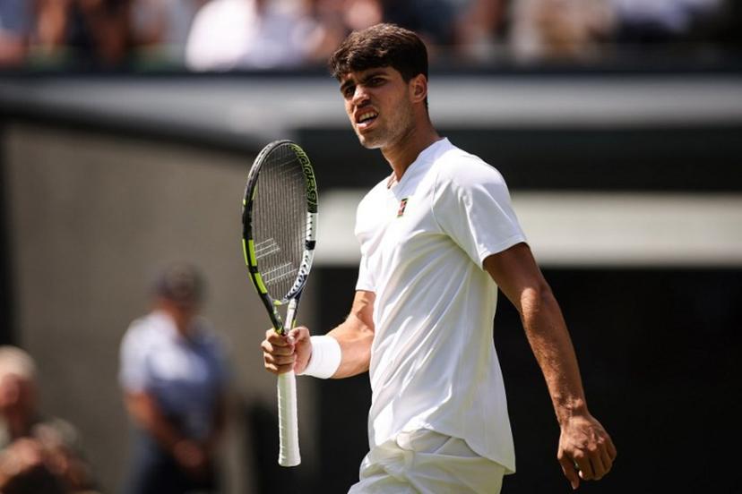 Spain's Carlos Alcaraz celebrates winning the first set to Italy's Fabio Fognini during their men's singles first round tennis match on the first day of the 2025 Wimbledon Championships at The All England Lawn Tennis and Croquet Club in Wimbledon, southwest London, on June 30, 2025.  HENRY NICHOLLS / AFP