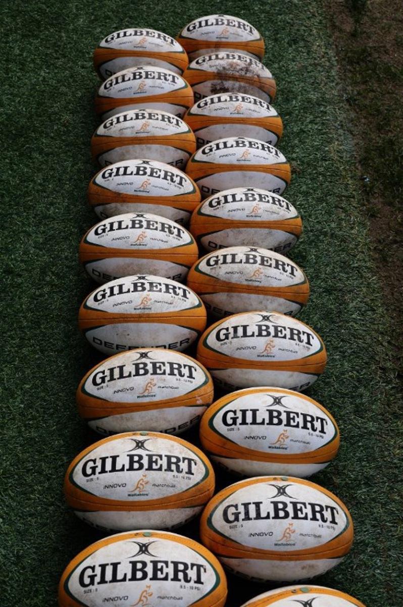 Rugby balls are lined up during the Australia's Captain's Run at Allianz Stadium on July 5, 2024 in Sydney ahead of the first rugby Test between Australian Wallabies and Wales.   DAVID GRAY / AFP